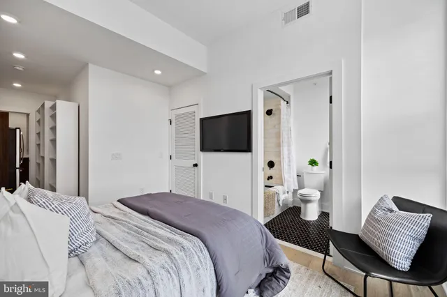 a bedroom with a bed and a television