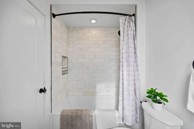 a bathroom with a shower and a mirror
