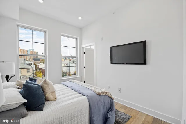 a bedroom with a bed and a flat screen tv