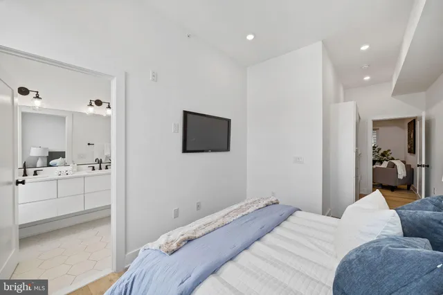 a bedroom with a bed and a view of bathroom