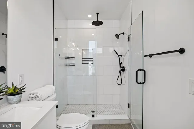 a bathroom with a shower toilet and sink