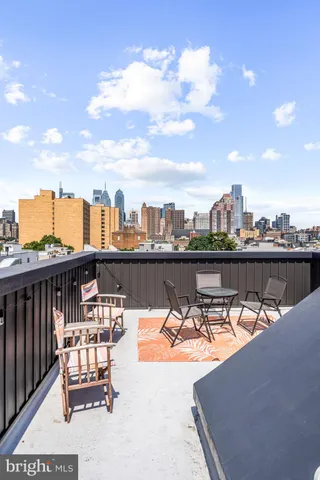 a view of a roof deck with furniture