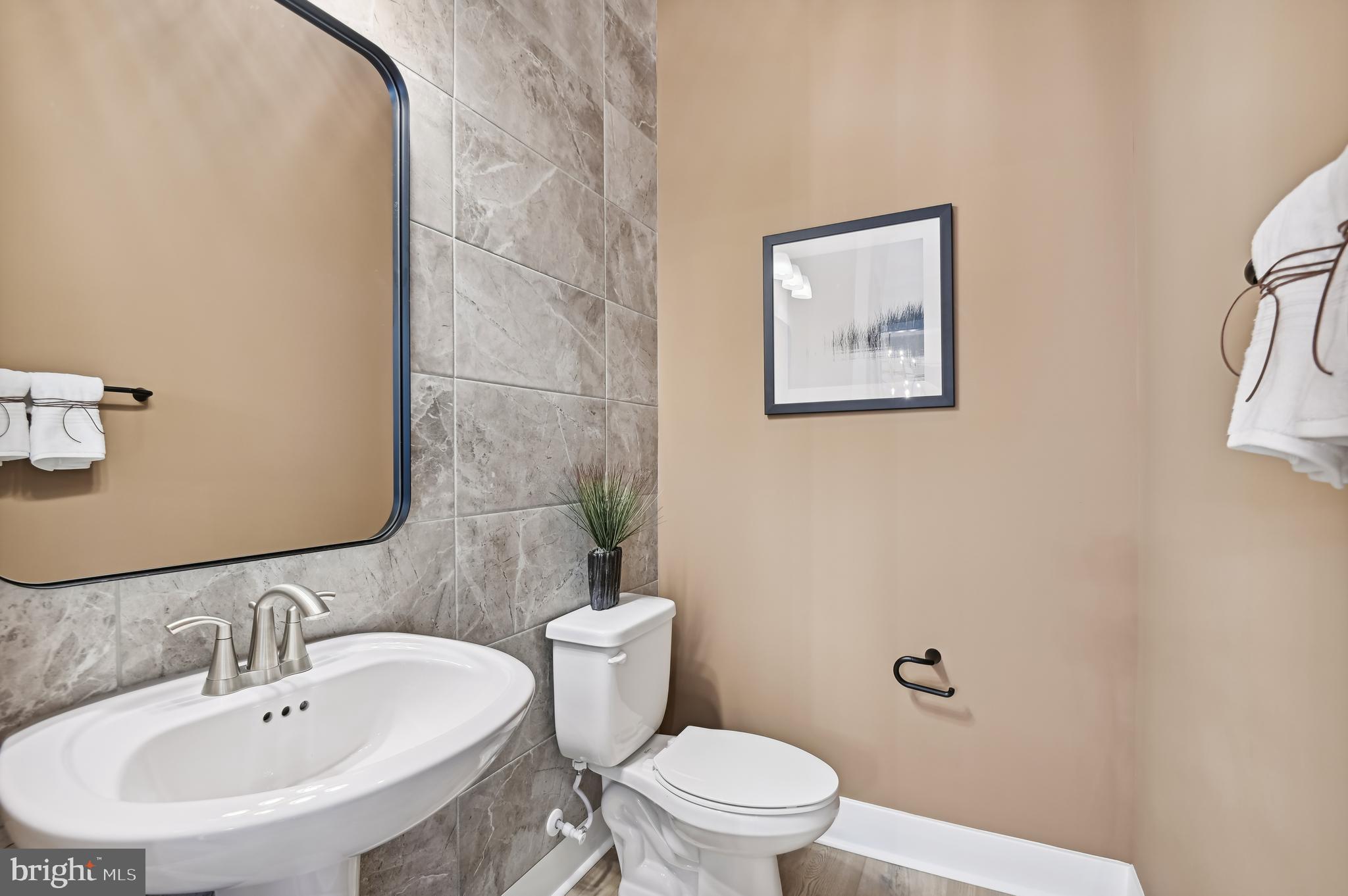 13812 Pecan Ridge Way Bowie, MD 20715 - Photo 20 of 44 a bathroom with a toilet a sink and mirror