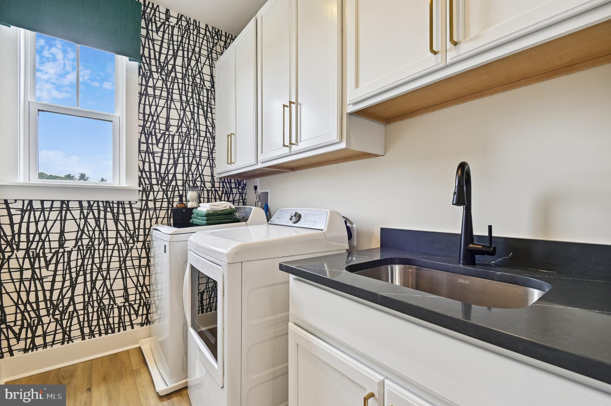 13812 Pecan Ridge Way Bowie, MD 20715 - Photo 30 of 44 a kitchen with stainless steel appliances granite countertop a sink and a white cabinets