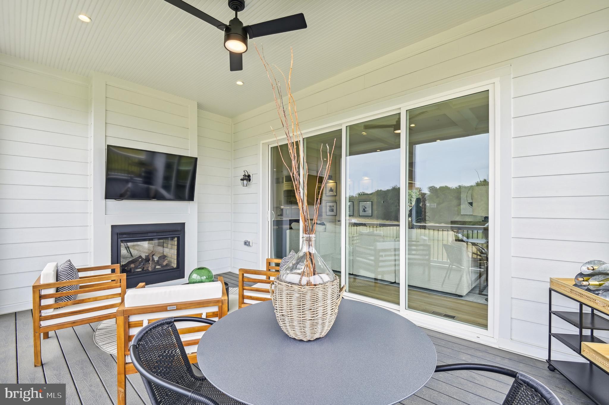 13812 Pecan Ridge Way Bowie, MD 20715 - Photo 44 of 44 a dining room with furniture a fireplace and wooden floor