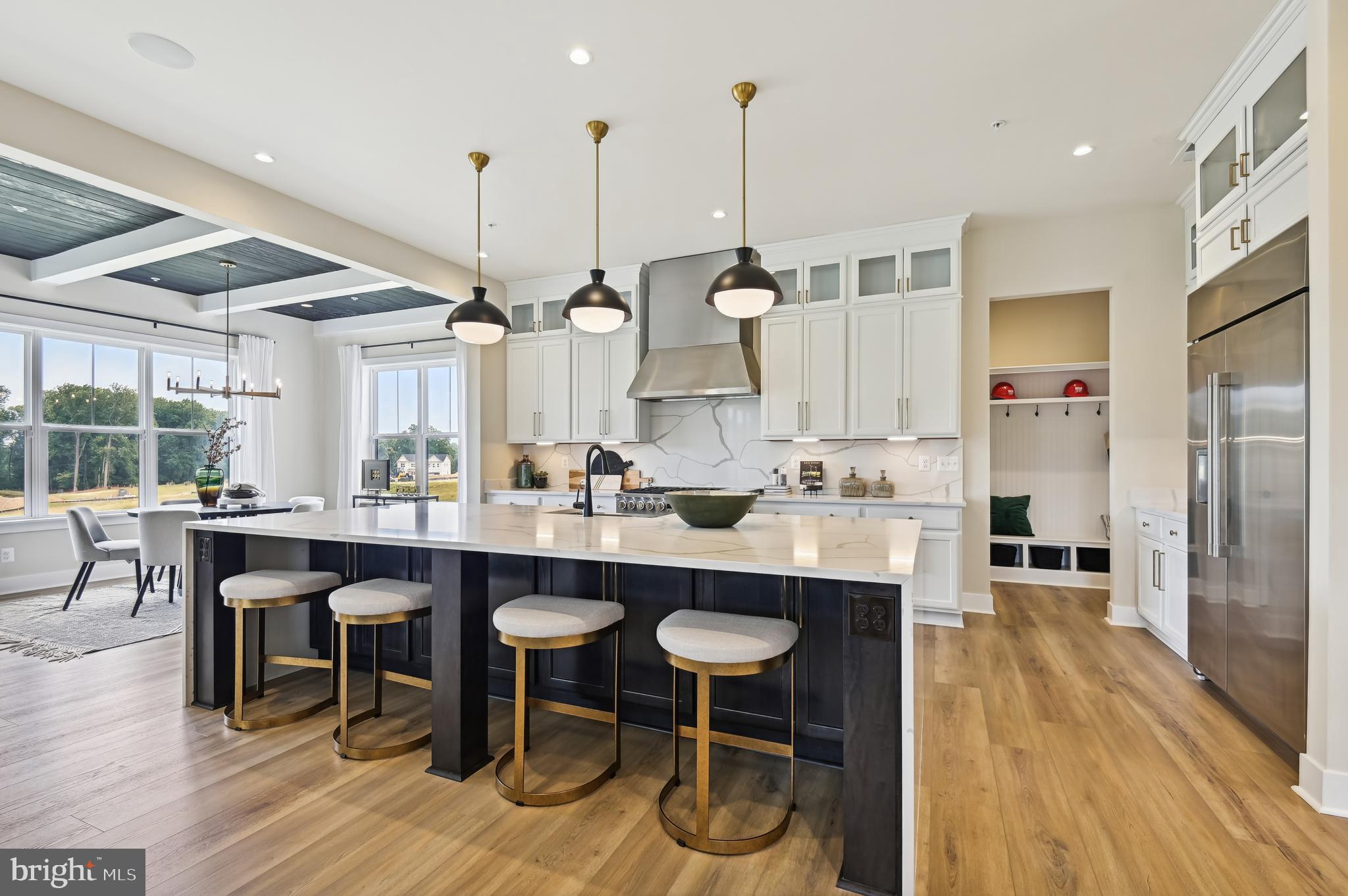 13812 Pecan Ridge Way Bowie, MD 20715 - Photo 8 of 44 a kitchen with stainless steel appliances granite countertop a table chairs sink and wooden floor