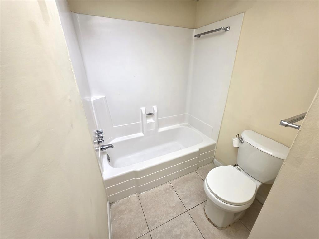 2800 Northwest 56th Avenue, Unit E304 Lauderhill, FL 33313 - Photo 11 of 15 a white toilet sitting next to a white sink and vanity