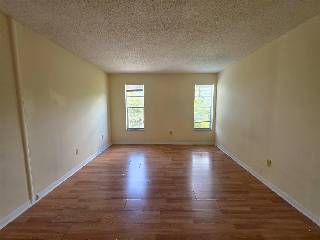 2800 Northwest 56th Avenue, Unit E304 Lauderhill, FL 33313 - Photo 6 of 15 an empty room with wooden floor and windows