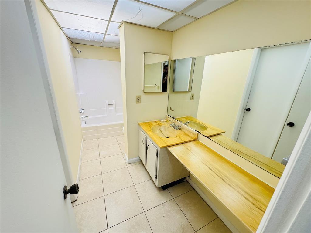 2800 Northwest 56th Avenue, Unit E304 Lauderhill, FL 33313 - Photo 10 of 15 a bathroom with a sink and a mirror