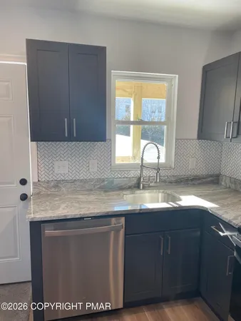 a kitchen with granite countertop a sink and a window