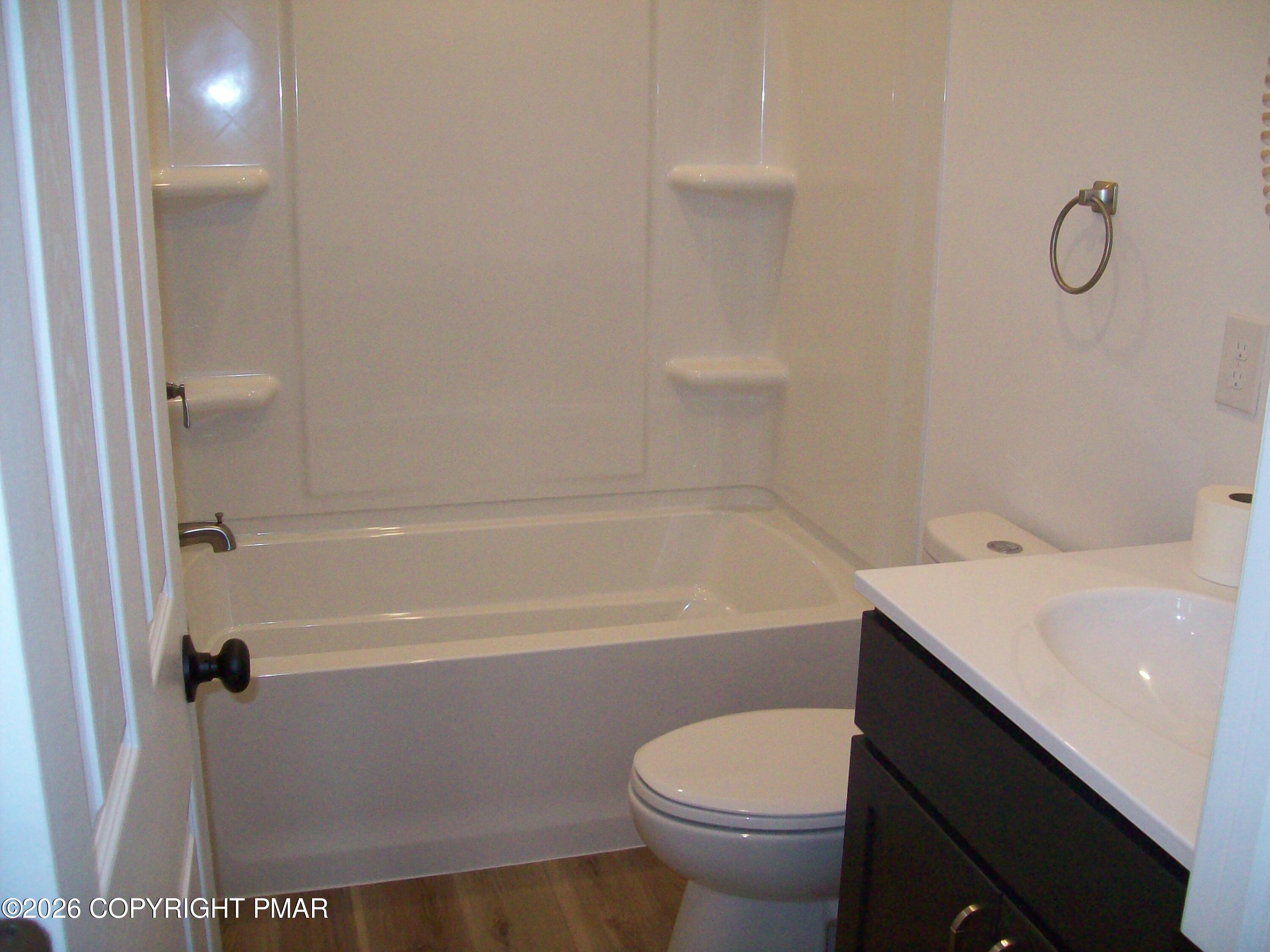 733 Ann Street, Unit 2 Stroudsburg, PA 18360 - Photo 9 of 16 a bathroom with a sink a toilet and bathtub