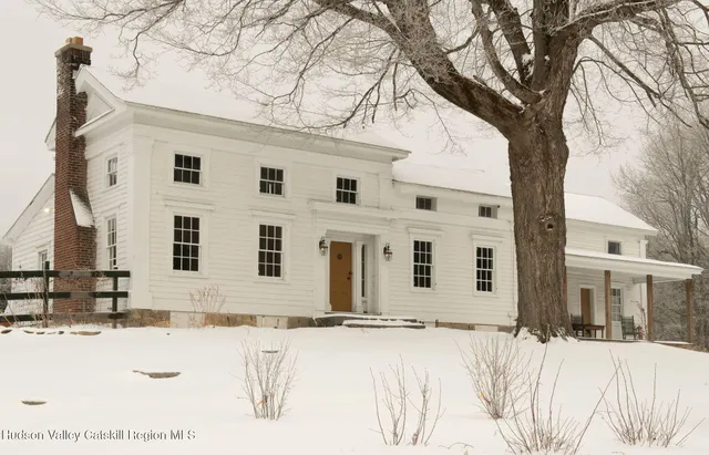 a view of a house with snow on the road