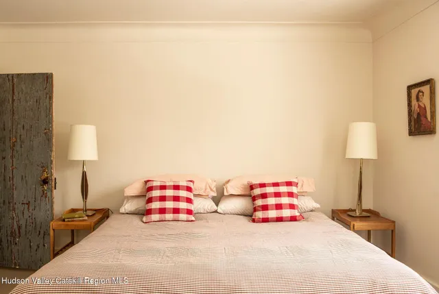 a bedroom with a bed and a lamp