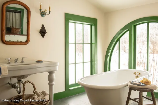 a white bath tub sitting next to a bathroom
