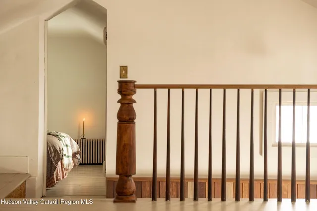 a bed sitting in a bedroom next to a window
