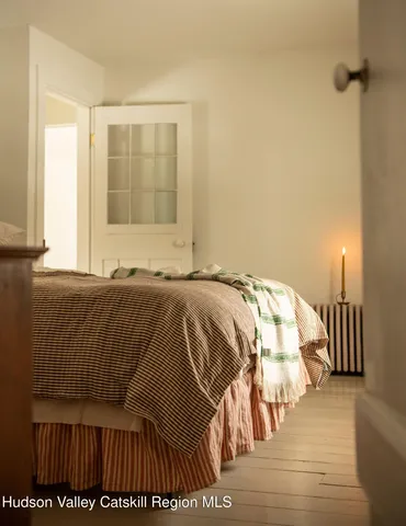 a bedroom with a bed and a mirror