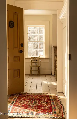 a view of a bedroom with wooden floor and windows