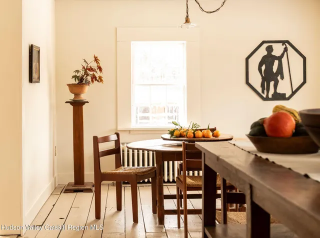 a view of a workspace with furniture and window