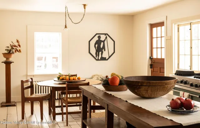 a dining room with furniture and window