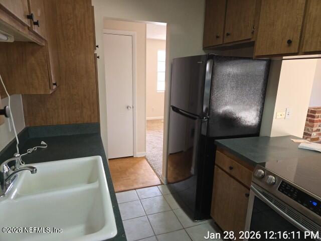 1130 Crown Drive Jacksonville, FL 32221 - Photo 13 of 27 a kitchen with a sink and a refrigerator