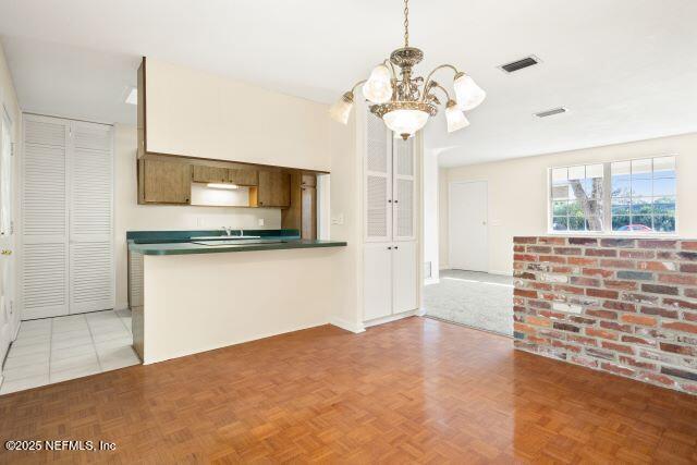 1130 Crown Drive Jacksonville, FL 32221 - Photo 9 of 27 a view of a kitchen with a sink and a chandelier