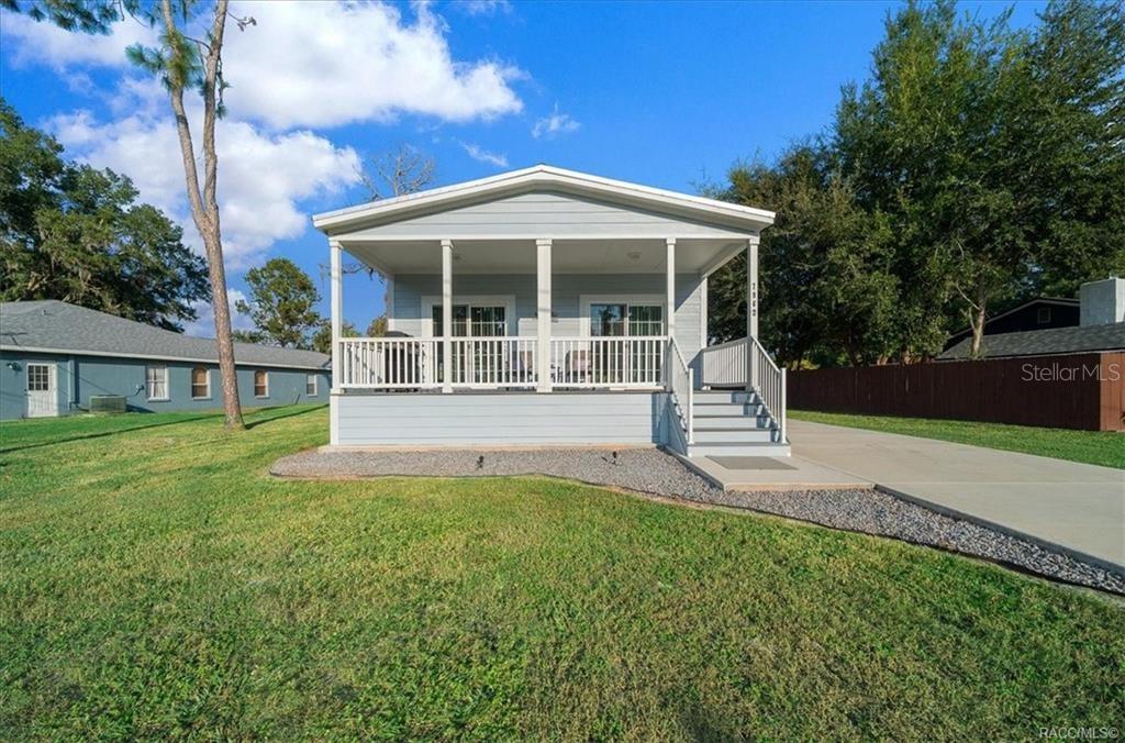 a view of a house with a yard and a garden