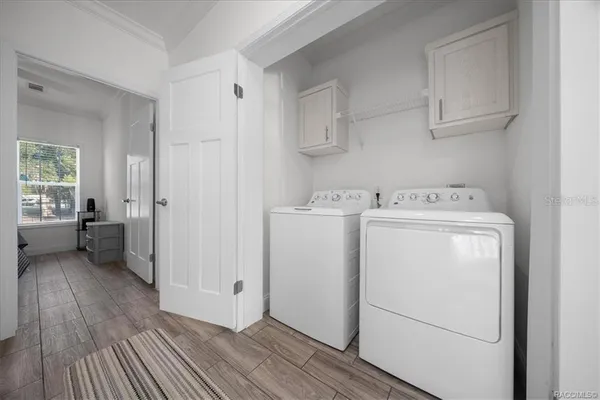 a kitchen with cabinets and a refrigerator