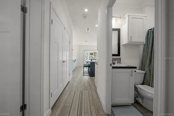 a bathroom with a sink a mirror toilet and bathtub