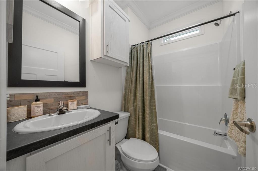 7962 West Riverbend Road Crystal River, FL 34428 - Photo 15 of 30 a bathroom with a sink a mirror toilet and bathtub