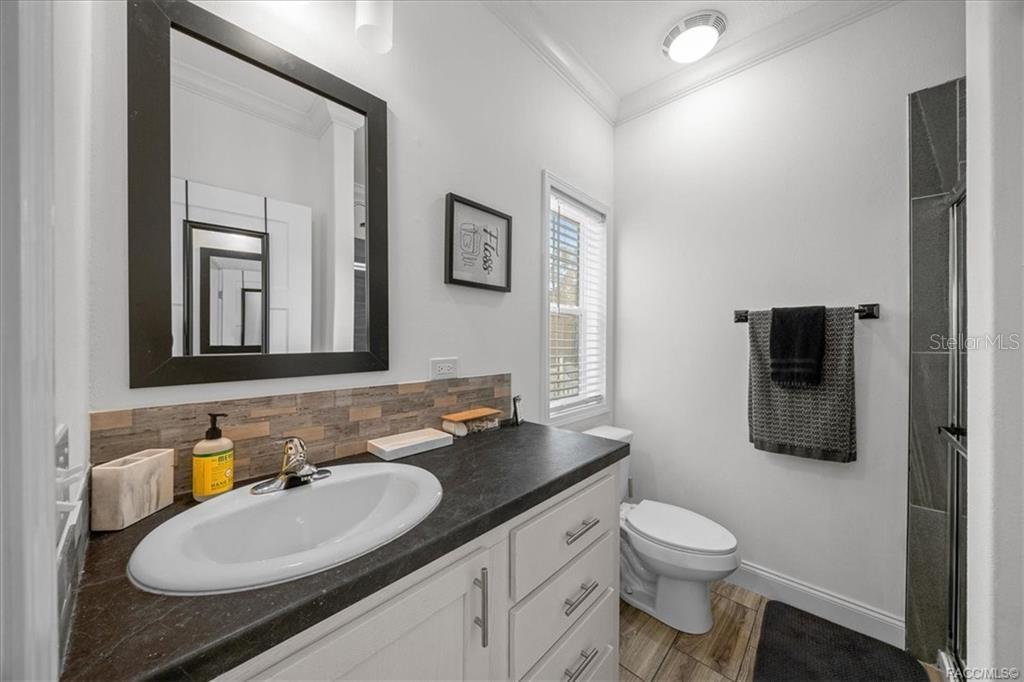 7962 West Riverbend Road Crystal River, FL 34428 - Photo 20 of 30 a bathroom with a toilet sink double vanity and mirror