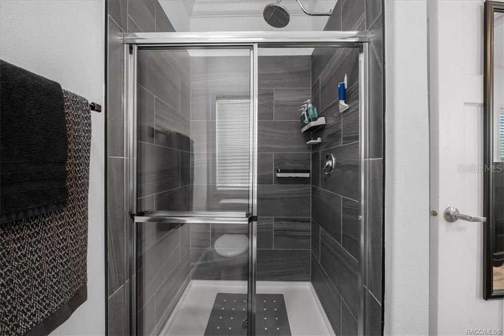 7962 West Riverbend Road Crystal River, FL 34428 - Photo 22 of 30 a bathroom with a glass shower door