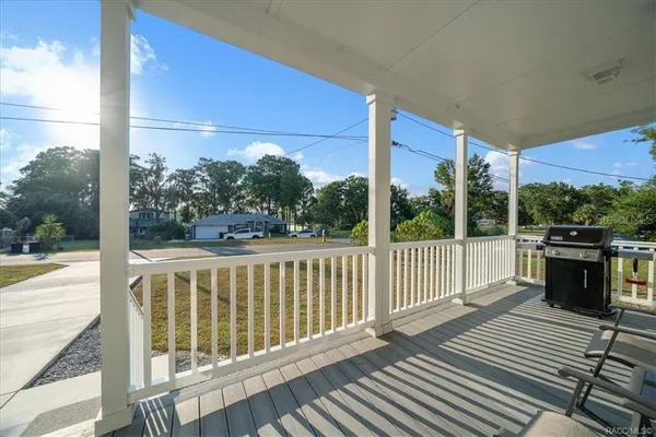 a view of a balcony with wooden floor