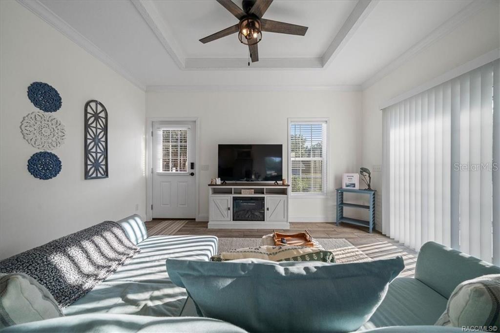7962 West Riverbend Road Crystal River, FL 34428 - Photo 5 of 30 a living room with furniture and a flat screen tv
