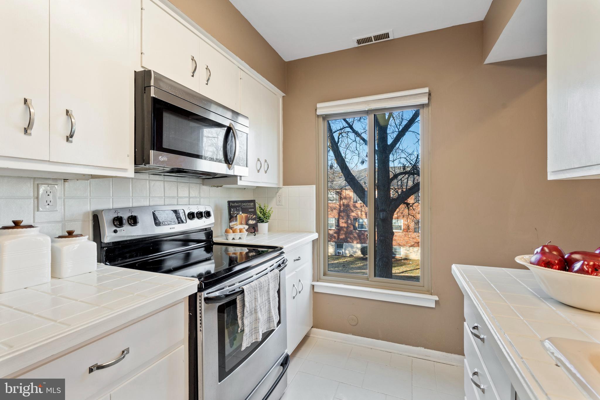 519 St Davids Road, Unit 3 Wayne, PA 19087 - Photo 13 of 31 a kitchen with stainless steel appliances granite countertop white cabinets a stove top oven a sink and dishwasher