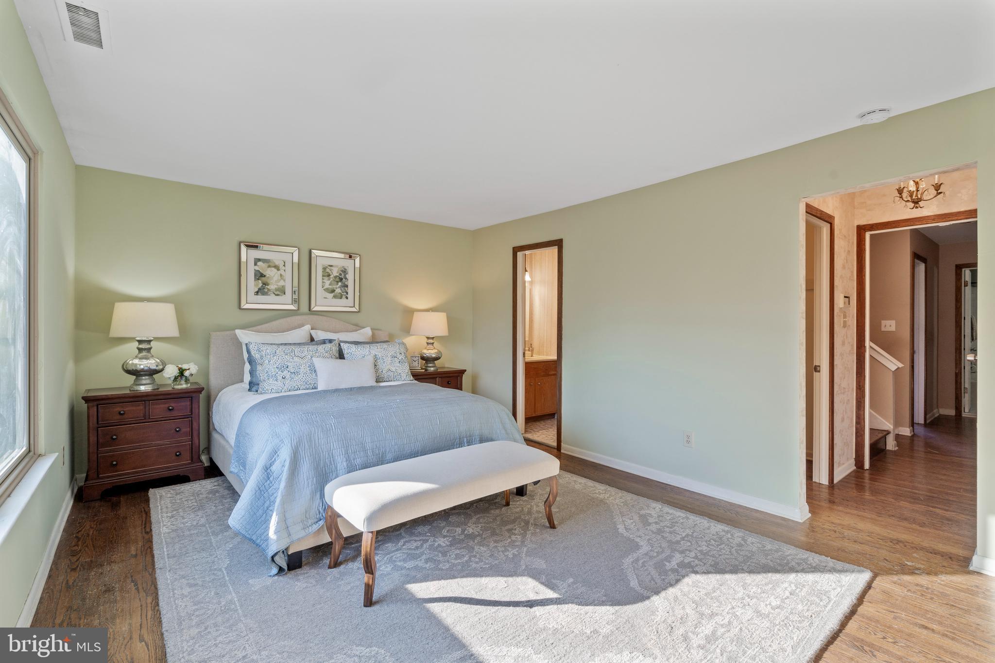 519 St Davids Road, Unit 3 Wayne, PA 19087 - Photo 19 of 31 a bedroom with a bed and wooden floor