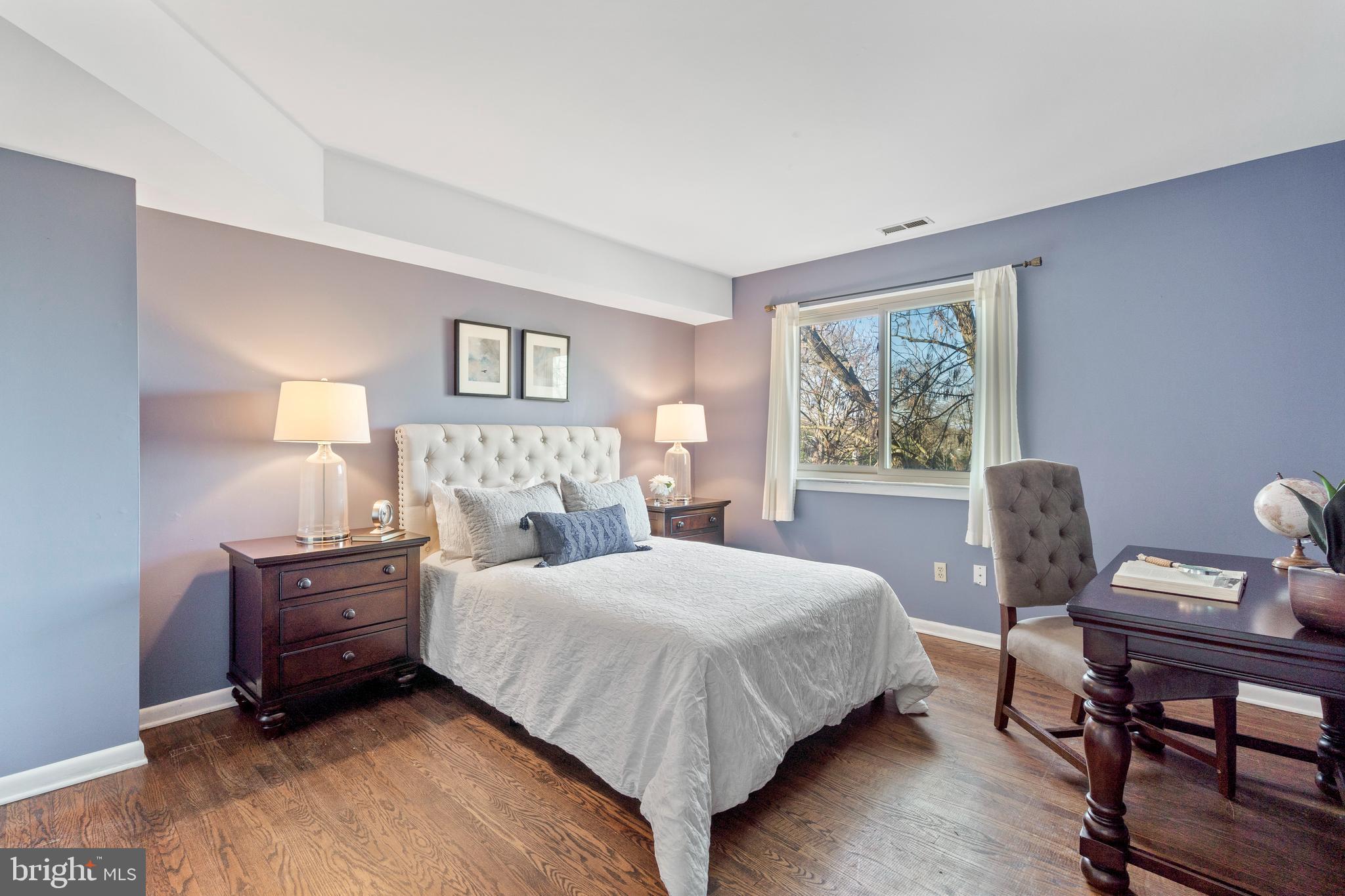 519 St Davids Road, Unit 3 Wayne, PA 19087 - Photo 21 of 31 a bedroom with a bed and wooden floor