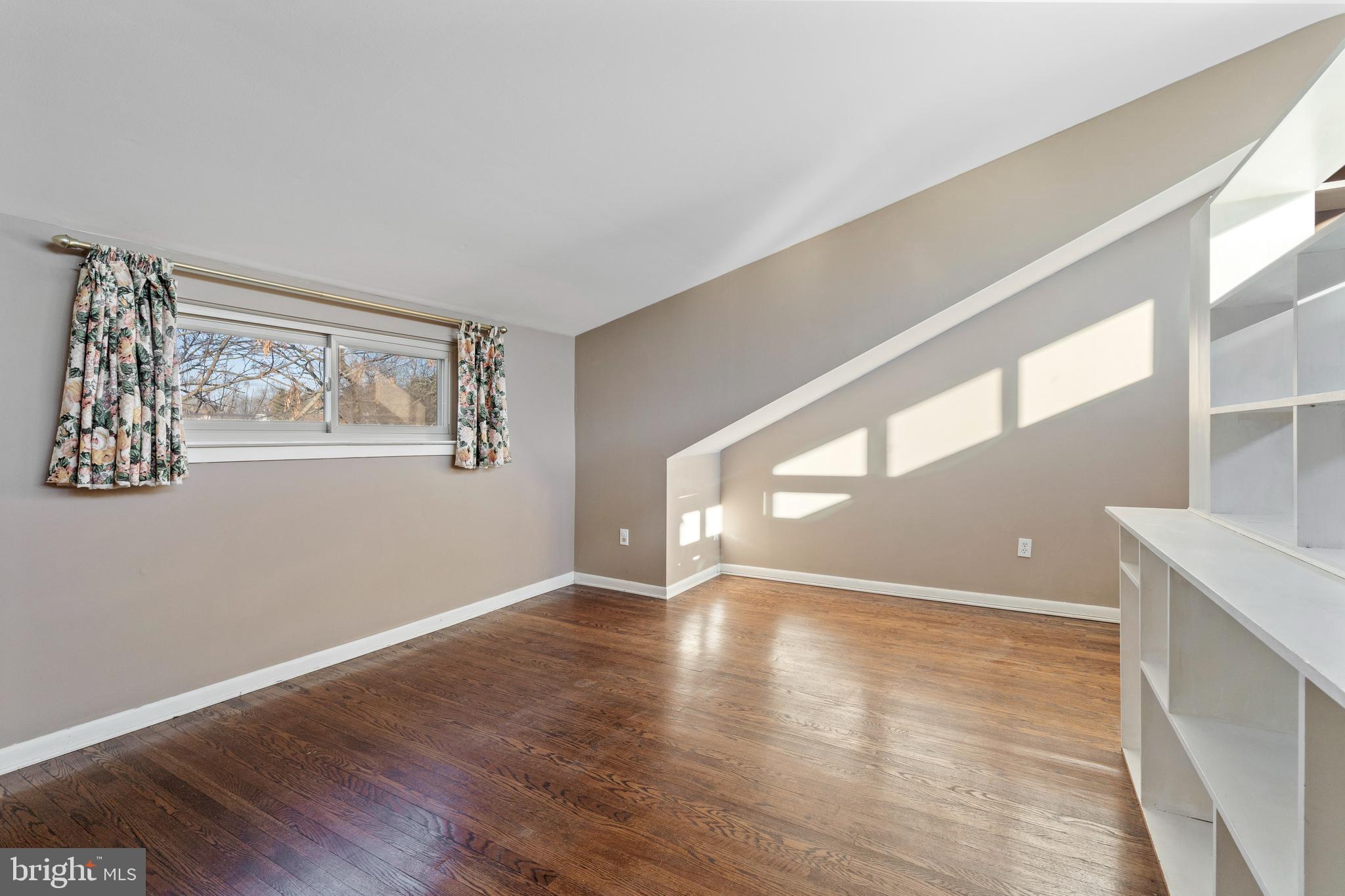 519 St Davids Road, Unit 3 Wayne, PA 19087 - Photo 26 of 31 a view of an empty room with wooden floor and a window