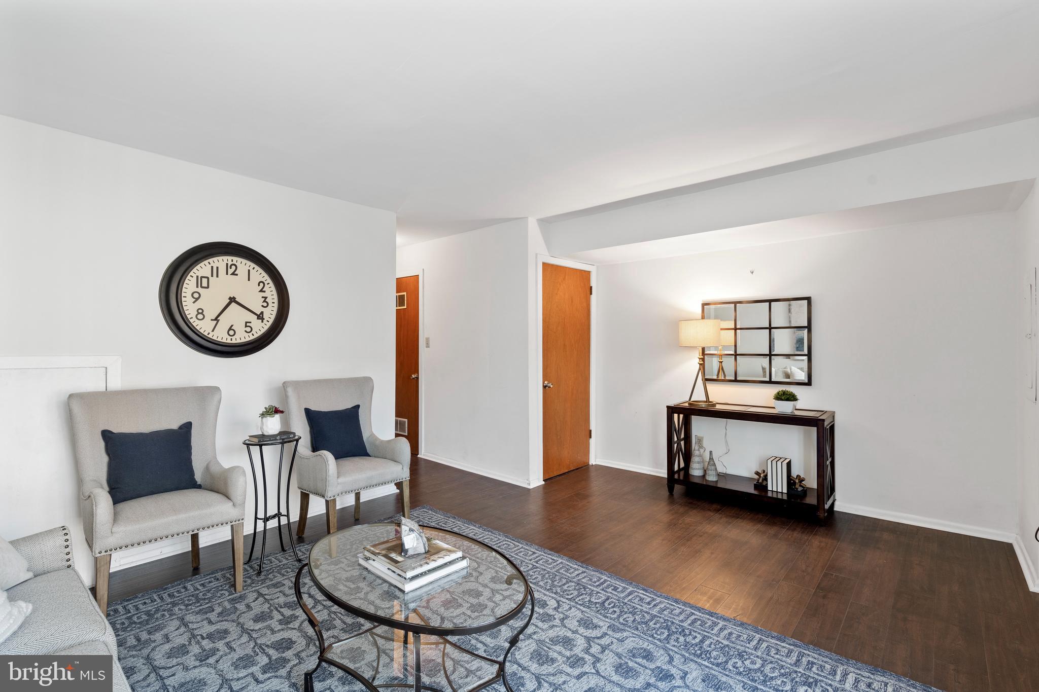 519 St Davids Road, Unit 3 Wayne, PA 19087 - Photo 29 of 31 a living room with furniture and a mirror