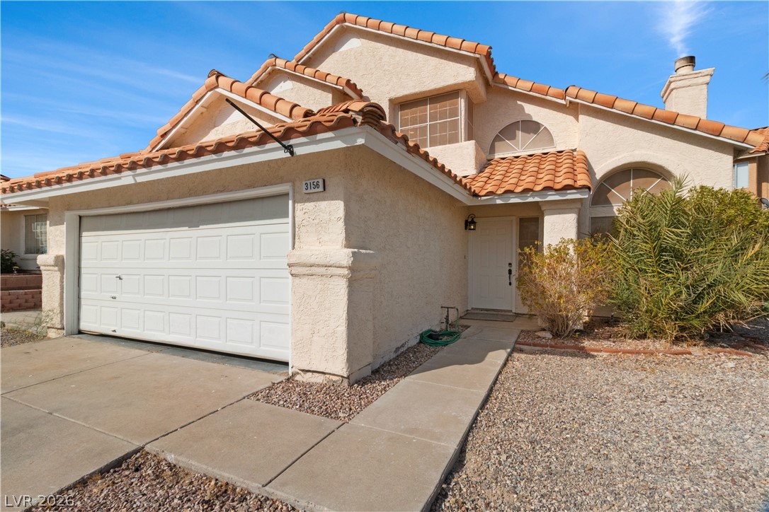 3156 Terrace View Drive Laughlin, NV 89029 - Photo 4 of 94 A charming stucco home with a terracotta tile roof and an attached garage.