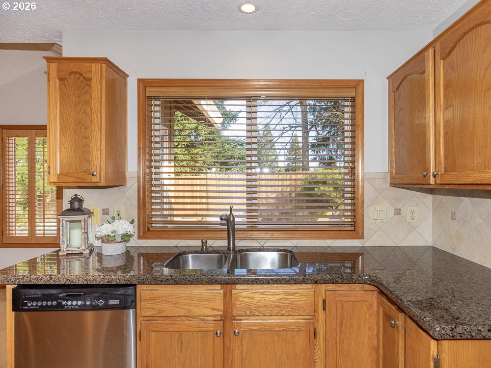 1811 Northwest 19th Street Gresham, OR 97030 - Photo 11 of 39 a kitchen with granite countertop sink and cabinets