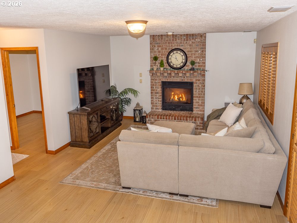 1811 Northwest 19th Street Gresham, OR 97030 - Photo 15 of 39 a living room with furniture a flat screen tv and a fireplace