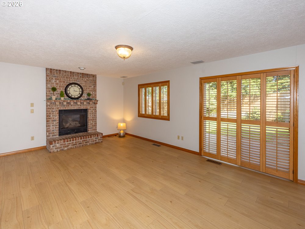 1811 Northwest 19th Street Gresham, OR 97030 - Photo 16 of 39 a view of an empty room with a fireplace and a window