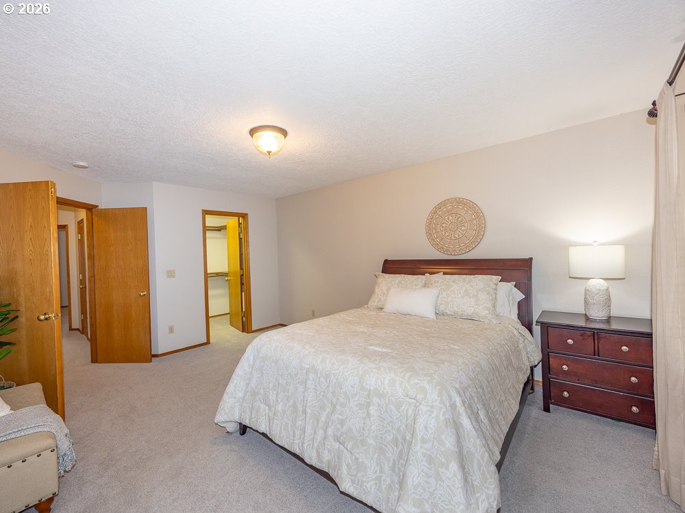 1811 Northwest 19th Street Gresham, OR 97030 - Photo 17 of 39 a bedroom with a bed and a lamp