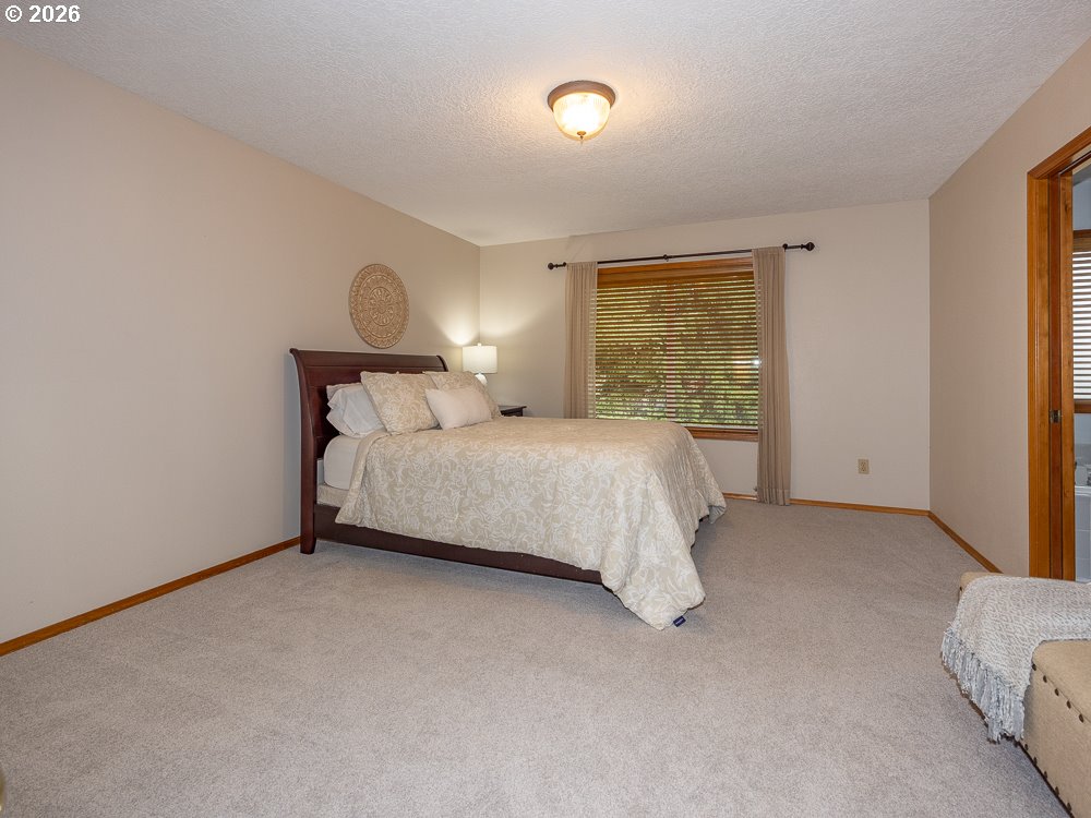 1811 Northwest 19th Street Gresham, OR 97030 - Photo 19 of 39 a bedroom with a bed and a night stand
