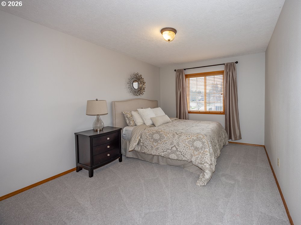 1811 Northwest 19th Street Gresham, OR 97030 - Photo 24 of 39 a bedroom with a bed and a window