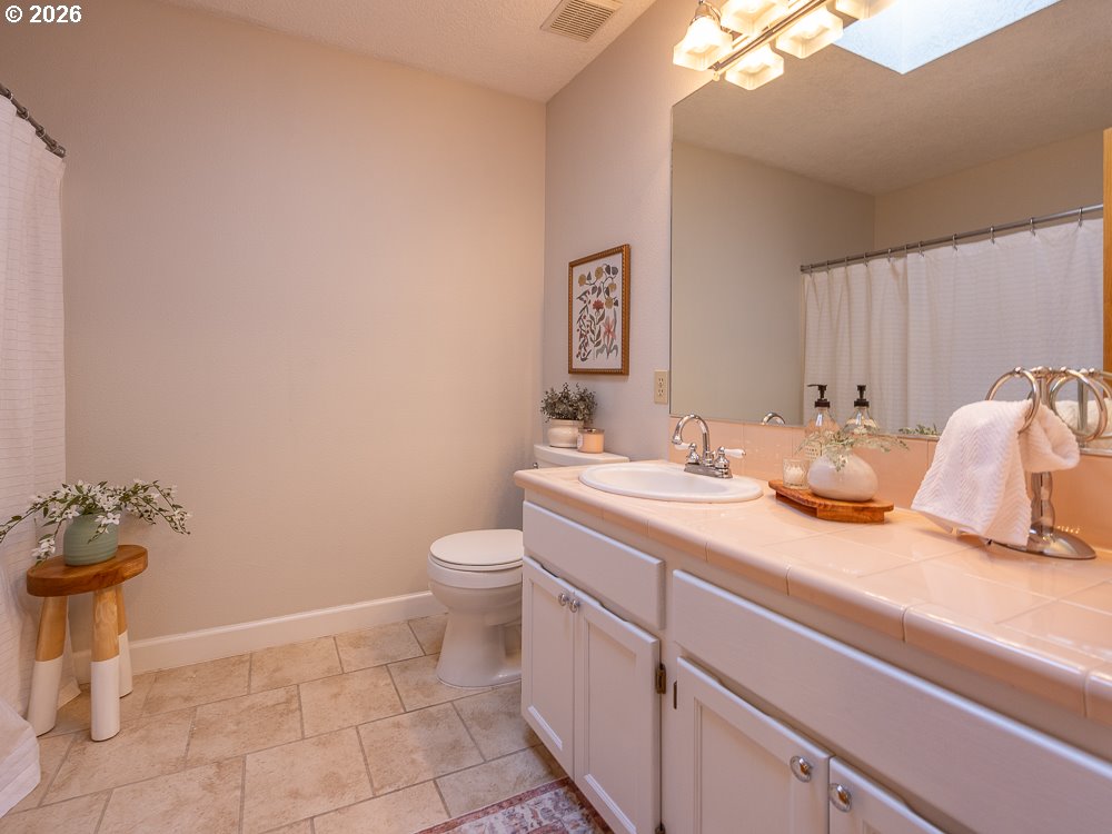1811 Northwest 19th Street Gresham, OR 97030 - Photo 29 of 39 a bathroom with a granite countertop sink and a toilet
