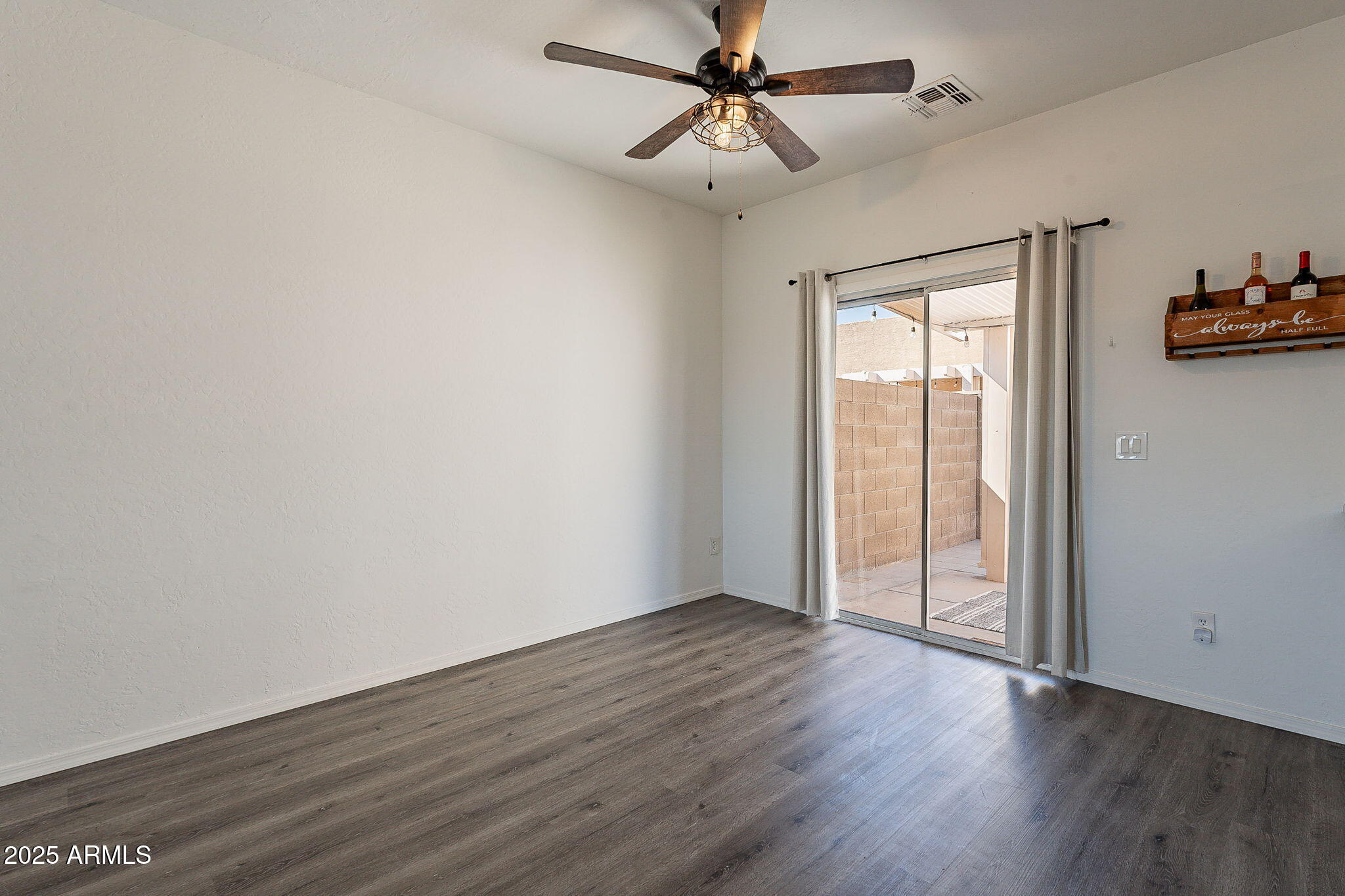 2300 East Magma Road, Unit 160 San Tan Valley, AZ 85143 - Photo 10 of 44 an empty room with wooden floor fan and windows