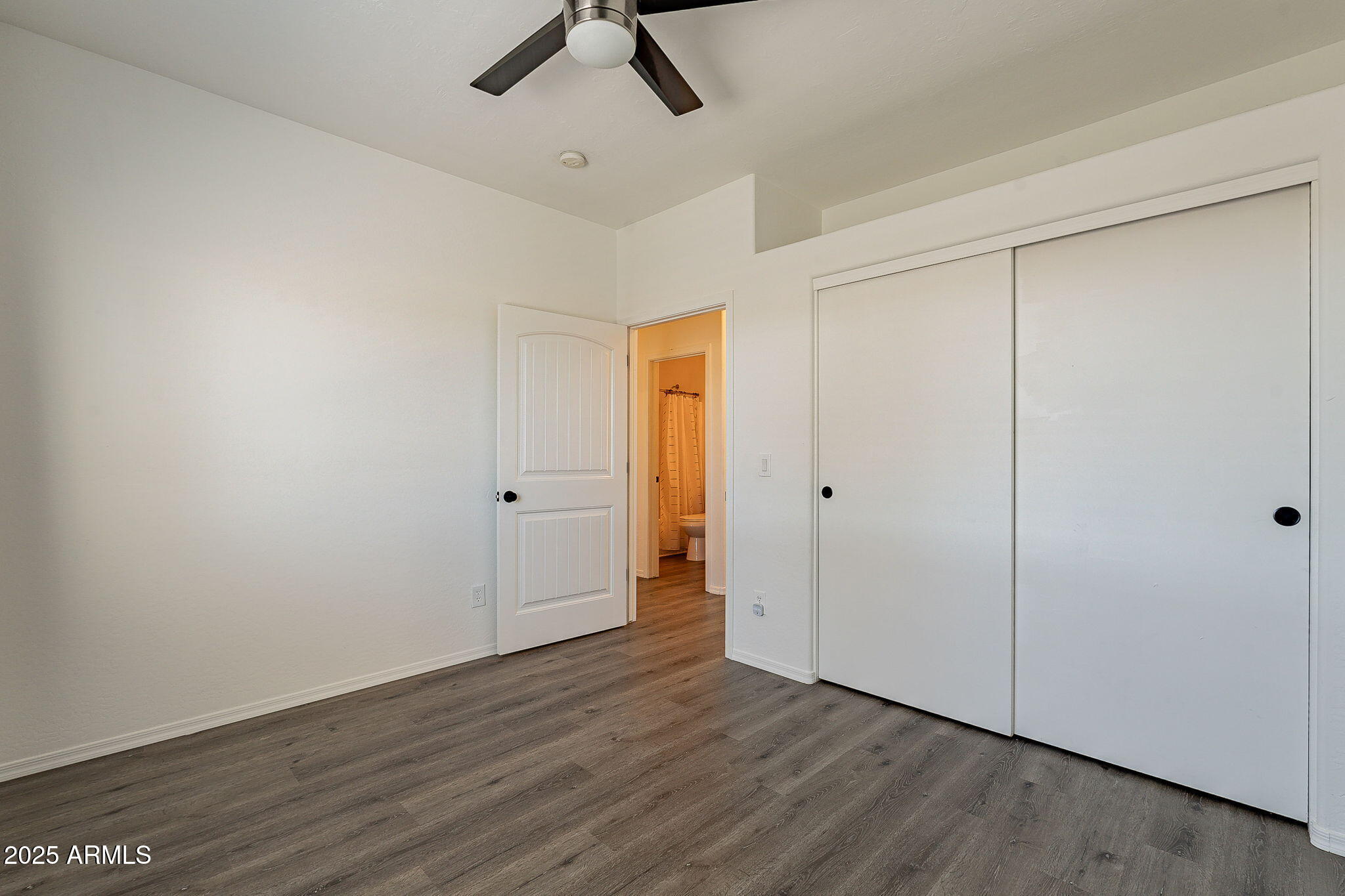 2300 East Magma Road, Unit 160 San Tan Valley, AZ 85143 - Photo 23 of 44 a view of an empty room with wooden floor