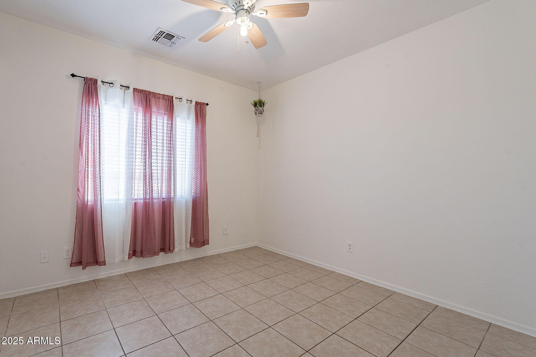2300 East Magma Road, Unit 160 San Tan Valley, AZ 85143 - Photo 24 of 44 an empty room with windows and fan