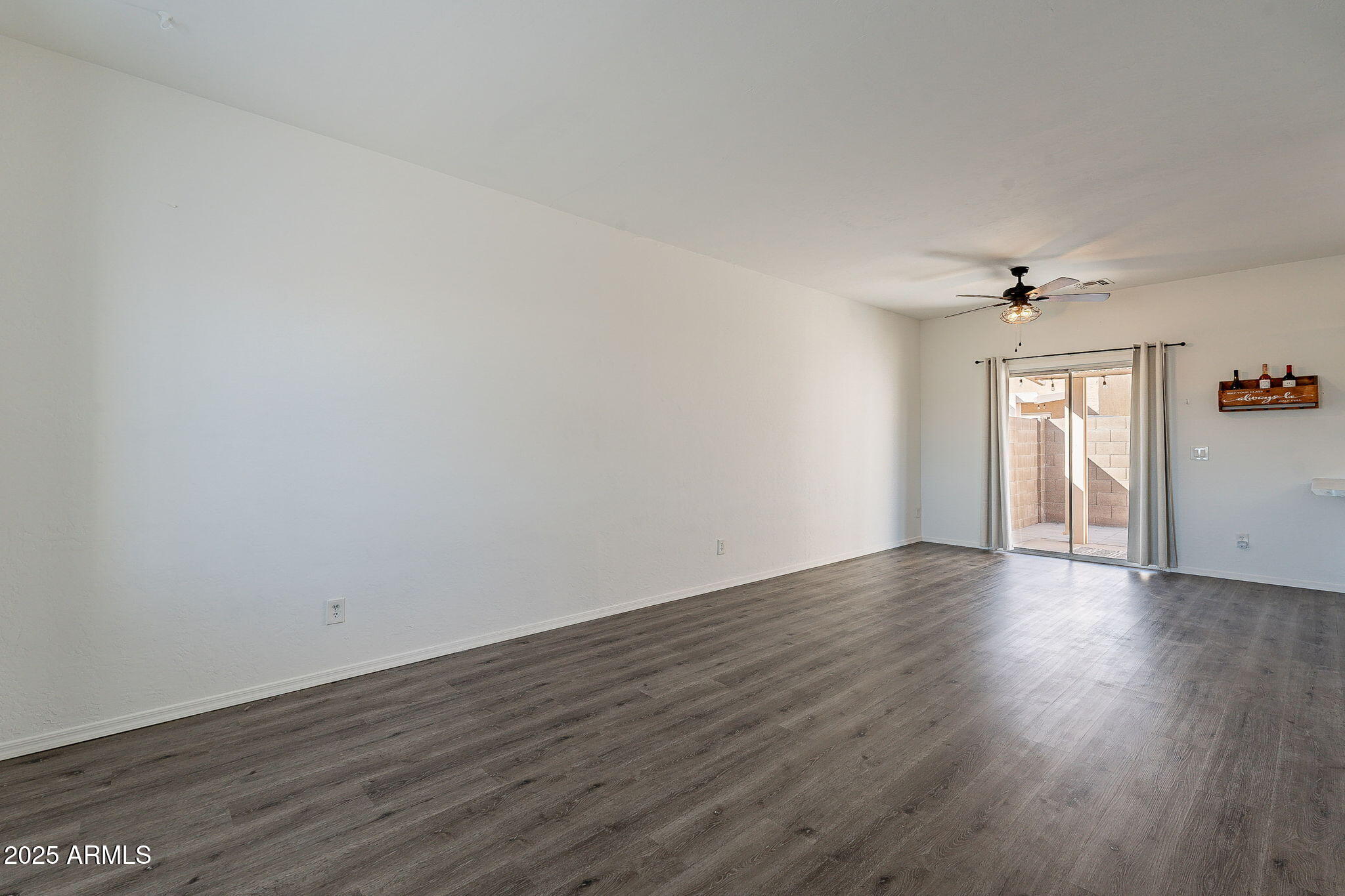 2300 East Magma Road, Unit 160 San Tan Valley, AZ 85143 - Photo 8 of 44 a view of an empty room with window and wooden floor